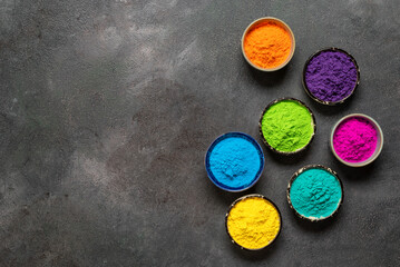 Organic colors Gulal in bowl for Holi festival on dark background. Colorful Holi powders. Top view, flat lay, copy space. - 746528703