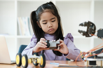 STEM education concept. Asian young girl learning robot design.