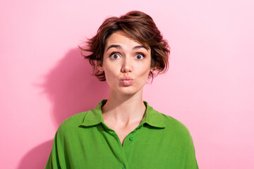 Photo of excited impressed lady wear green shirt lips pouted sending kiss isolated pink color background