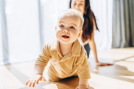 Baby Crawling in Front of Woman