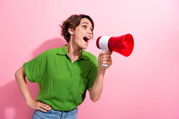Photo portrait of attractive young woman hold shout megaphone empty space dressed stylish green...