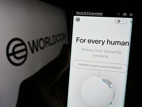 Stuttgart, Germany - 02-15-2024: Person holding cellphone with webpage of cryptocurrency project Worldcoin (Tools for Humanity) in front of logo. Focus on center of phone display.