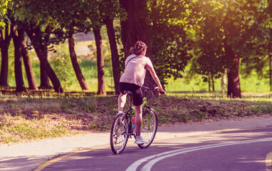 Cyclist ride on the bike path in the city Park
