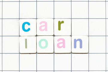 Colorful tile letter in word car loan on white grid background