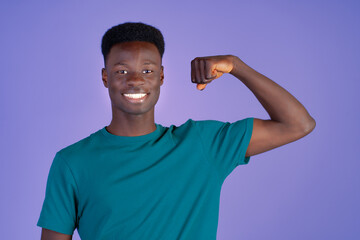 A man is showcasing his muscular physique with a big smile on his face. His biceps and chest muscles are visibly defined as he flexes them proudly.