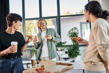 happy men enjoying a pizza in a friendly and relaxed atmosphere, startup team having lunch break