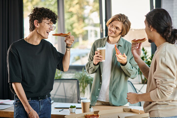 smiling men enjoying a pizza lunch break in a friendly and relaxed office atmosphere, startup team