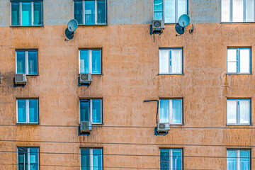 A fragment of the facade of an old multi-storey apartment building on a winter day