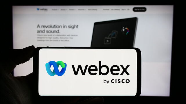 Stuttgart, Germany - 02-19-2024: Person holding mobile phone with logo of American unified communications company Webex by Cisco in front of web page. Focus on phone display.