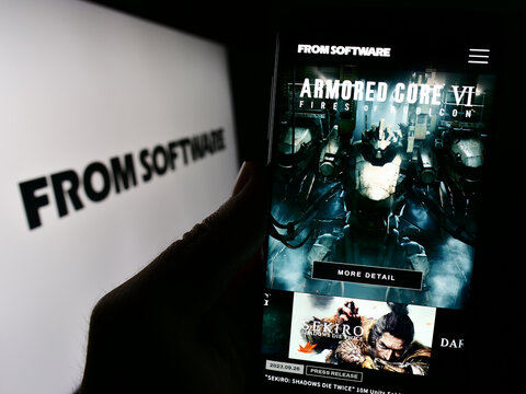 Stuttgart, Germany - 02-19-2024: Person holding smartphone with webpage of Japanese video games company FromSoftware Inc. in front of logo. Focus on center of phone display.