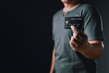 businessman showing a mock-up credit card for business and shopping to make payment and smartphone.half body. purchase, commerce, financial, card, money, using technology. selective focus.