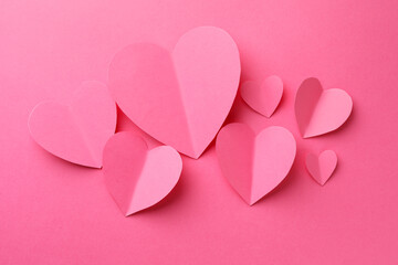 Paper hearts on pink background, flat lay