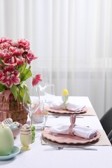 Festive table setting with beautiful flowers. Easter celebration