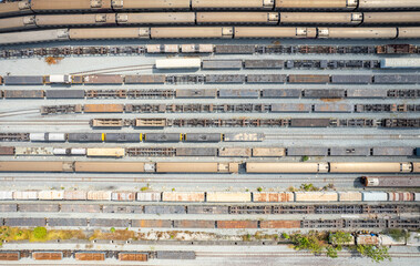 Aerial top view Passenger and freight trains on the railway yard for transportation background. wagons with goods on railroad.