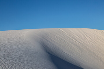 Blue sky over white gypsum sand dunes, at White Sands National Park in New Mexico