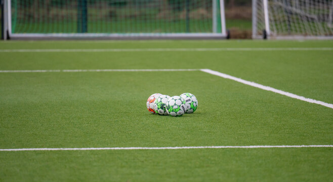 Hamburg, Germany - Februrary 24, 2024: Derbystar footballs on an artificial turf football pitch