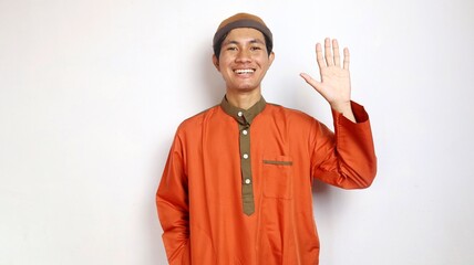 asian muslim man gesture waving and raising hand