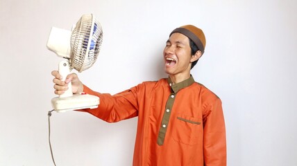 asian muslim man gesture holding fan