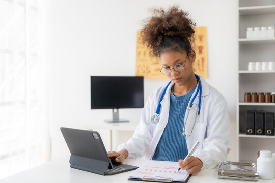 Cute smart African American female doctor wearing a headset giving online healthcare advice via webcam video chat and patient consultation, online or telemedicine services.