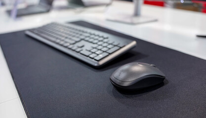 Computer mouse and keyboard on a mouse pad. Technology and IT concept.