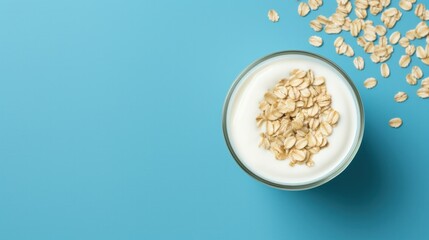 Yogurt served with dry oatmeal on a blue background - obrazy, fototapety, plakaty