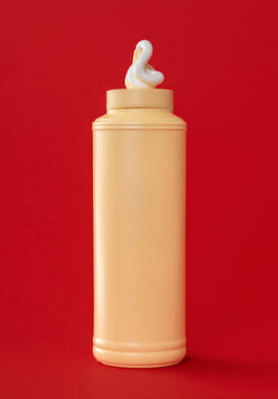 Mayo plastic bottle isolated on a red background