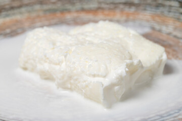 Fototapeta na wymiar Buffalo cream. Dairy products. Fresh buffalo cream in a plate. Close up