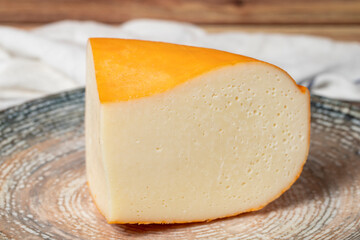 Gouda cheese. Dairy products. Slices of Gouda cheese on a plate. Close up