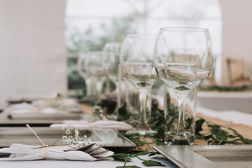 Elegant table setting for a dinner with cups, plates and flowers in a reception