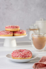 Food photography of doughnut, donuts, glazed, tea, coffee, milk, bagel, bakery, baking, pastry, pink, treat, dessert, sprinkles, calories, icing, candy