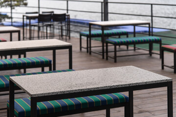 empty tables and chairs at the riverside cafe in autumn