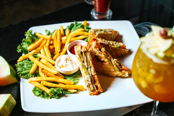 White Plate With French Fries and Sandwich