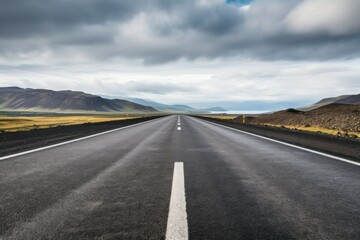 Fototapeta premium Dimming view of empty road with road markings passing over lake view with clear sky