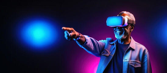 Old smiling African man wearing virtual reality glasses and touch with his finger to the side.