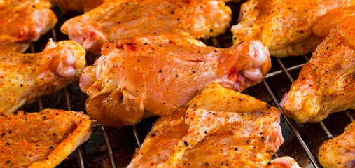 Chicken wings barbecue roasted cooking with spices. Fried chicken wings, homemade, food for restaurant, menu, advert or package, close up. American cuisine. - 746597306