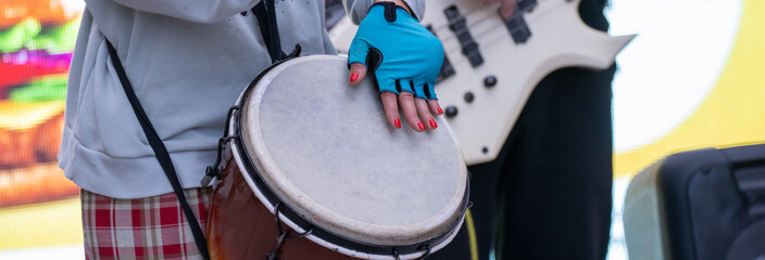 Woman playing drum on the street
