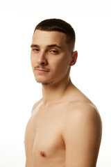 Naklejka premium Portrait of shirtless handsome man with trimmed beard, looking confidently at camera against white studio background. Concept of beauty procedures, male health, body care, spa treatment, hygiene.