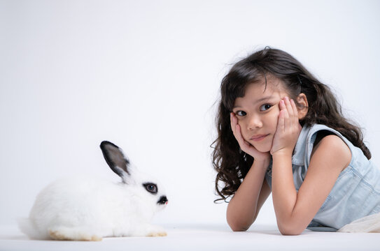 Smiling little girl and with their beloved rabbit, showcasing the beauty of friendship between humans and animals