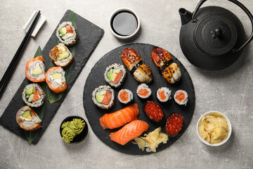 Flat lay composition with delicious sushi rolls on light grey table © New Africa