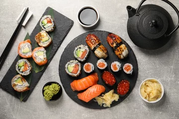 Fensteraufkleber Flat lay composition with delicious sushi rolls on light grey table © New Africa