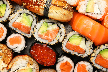 Different tasty sushi rolls as background, top view © New Africa