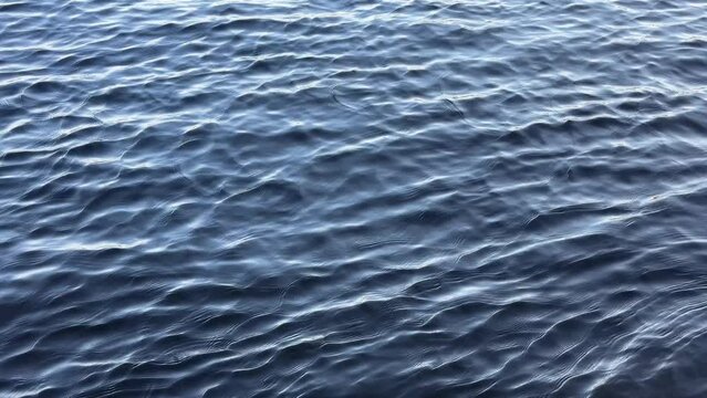 Blue river water rippled surface.
