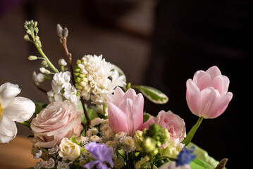 a beautiful delicate spring bouquet of tulips, buttercups and muscari, floral arrangement	

