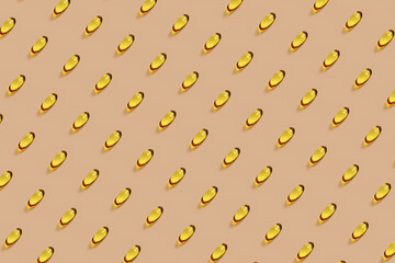 Omega-3 oil vitamin capsules in pattern on peach background
