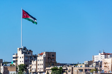 Large Jordanian flag flying over the city of Amman, Jordan - 746612311