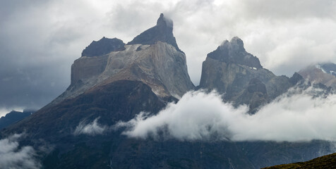 Majestic Mountain Peaks Emerge from Misty Clouds