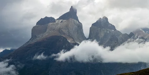 Foto auf Acrylglas Cuernos del Paine Majestic Mountain Peaks Emerge from Misty Clouds