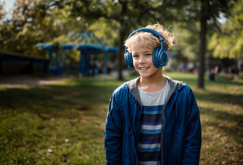 Blonde boy listening music in headphones