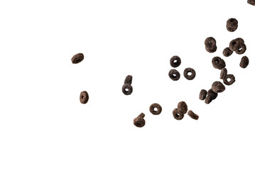 Chocolate rings cereal spill out into a bowl. Breakfast.