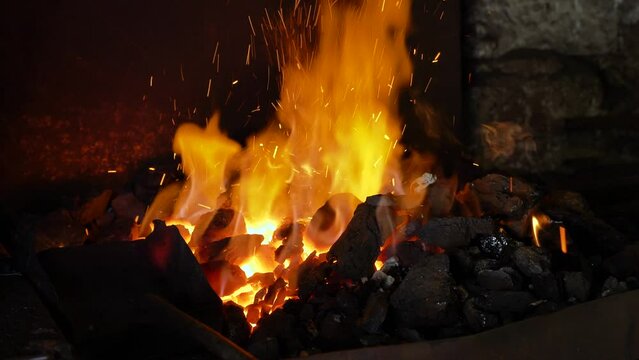 Burning fire, blacksmith prepares fire for work.